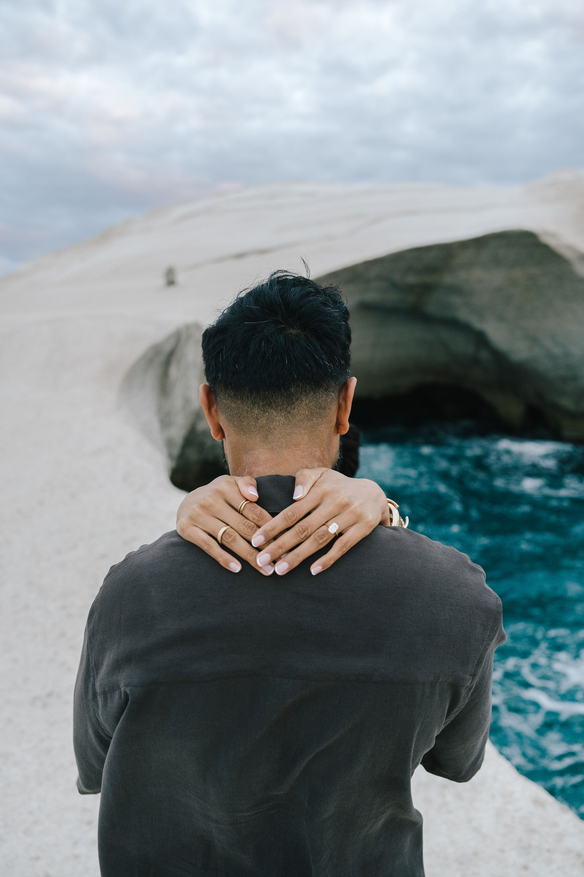 Romantic couple portrait among the white volcanic rocks of Sarakiniko